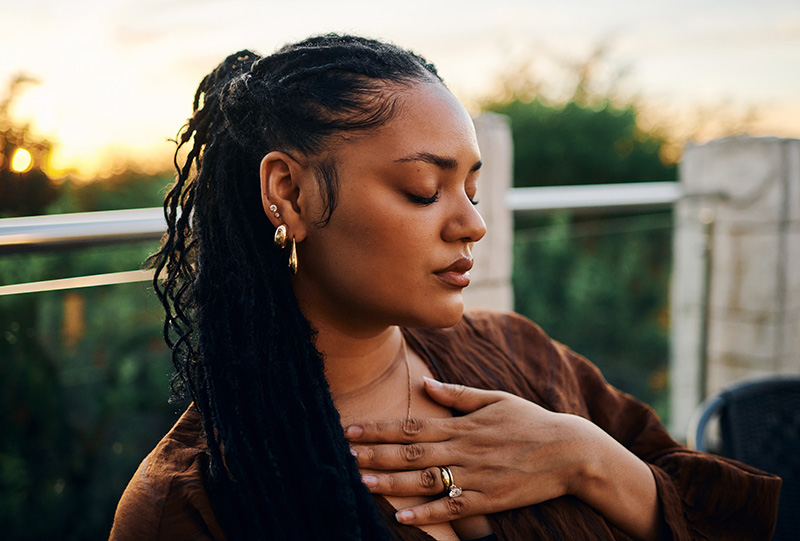 Serene Woman with Closed Eyes at Sunset